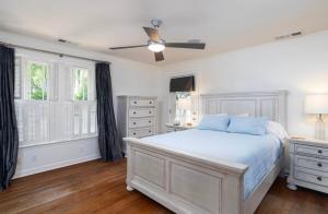 a white bedroom with a bed and a ceiling fan at Walk to Oxford Square, Faulkner house, Ole Miss in Oxford