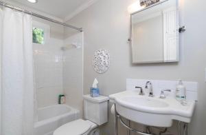 a white bathroom with a sink and a toilet at Walk to Oxford Square, Faulkner house, Ole Miss in Oxford +13 photos