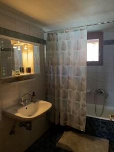 a bathroom with a sink and a shower curtain at Kyparissos Home , Arachova in Arachova +23 photos