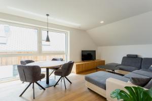 a living room with a couch and a table at Sunny Green Escape in Lesce