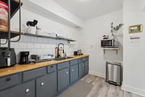 a kitchen with blue cabinets and a counter top at 2BR Apt 3 mins Paseo, 8 mins Downtown, Unit 2 in Oklahoma City