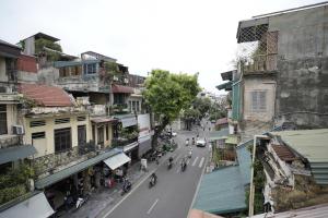 a view of a city street with motorcycles and buildings at Bu House Hanoi Old Quarter in Hanoi