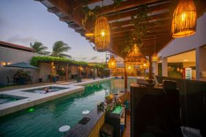 a swimming pool with a bar in a hotel at Paraiso Beach Hotel in Aquiraz