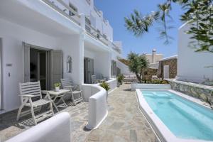 a villa with a swimming pool and a patio at Nodo Boutique Hotel in Mýkonos City