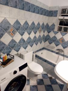 a bathroom with a toilet and a sink and a tub at ATHENA'S Central APP in Samos