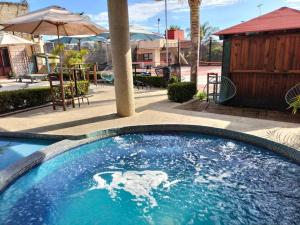 a swimming pool with blue water in a resort at Hotel Bungalows La Era in Ixtapan de la Sal