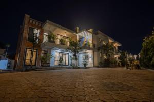 a large house at night with a cobblestone street at Airgo Residences in Kigali