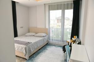 a bedroom with a bed and a large window at Villa Opera Kemer Müstakil Villa in Kemer +13 photos