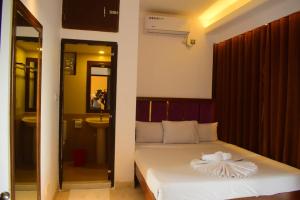 a bedroom with a bed with a towel on it at Needs Bay Watch in Cox's Bazar
