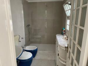 a bathroom with a toilet and a tub and a sink at Casa na praia- Maia in Maia