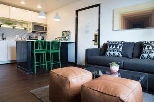 a living room with a couch and a table at The Sobro Guest House by AvantStay in Nashville