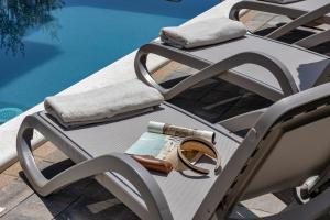 a pair of wedding rings sitting on a chair by a pool at Blue Dream - La Luna Residence in Tučepi