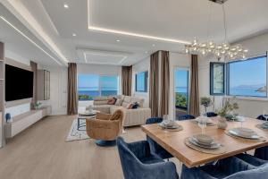 a living room with a dining table and a couch at Blue Dream - La Luna Residence in Tučepi