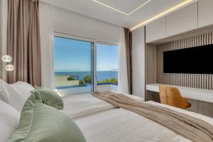 a bedroom with a large window and a television at Blue Dream - La Luna Residence in Tučepi +54 photos