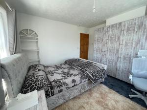 een kleine slaapkamer met een bed en een bureau bij South Coast Guest Rooms With free onsite Parking in Poole