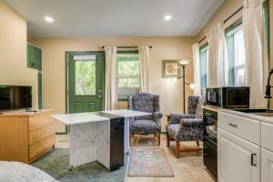 a kitchen with a table and two chairs and a microwave at Less Than half Mi to OSU Studio in Corvallis Near Parks in Corvallis