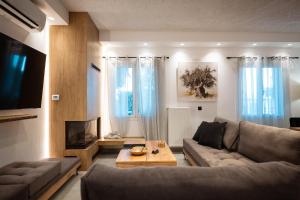 a living room with a couch and a coffee table at Nicolas Villa in Anavissos