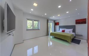 a bedroom with a bed and a flat screen tv at Amazing Home In Crikvenica in Crikvenica