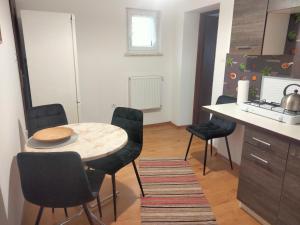 a kitchen with a table and chairs and a desk at Pokoje w Pucku u Ewy in Puck