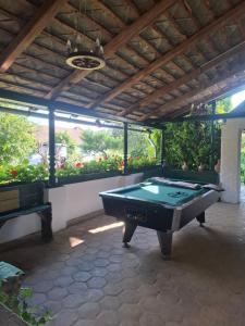 a pool table in a patio with a roof at Szent Flórián Vendégház in Szakcs