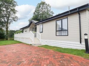 a house with a brick driveway in front of it at The Maples 44 in St Austell