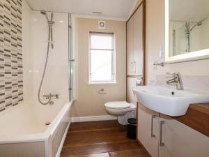 a bathroom with a sink and a toilet and a shower at The Maples 44 in St Austell +16 photos