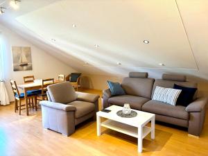 a living room with two couches and a table at Ferienwohnung-Charly in Mettlach