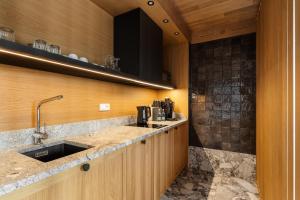 a kitchen with a sink and a counter at IJG Imperial Apartamenty Smrekowa in Zakopane +71 photos