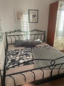 a bedroom with a bed with a black metal frame at Chill house in Makarska