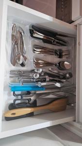 a drawer full of utensils in a kitchen at Emari - Hochwertige 2-Zimmer-Wohnung mit Panorama Bergblick in SJJ