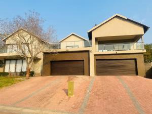 a house with two garage doors in a driveway at Tan Ridge Hill in Vosburg