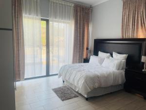 a bedroom with a bed and a large window at Tan Ridge Hill in Vosburg