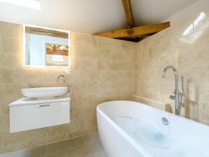 a bathroom with a tub and a sink at 1 Bed in Dulverton 59339 in Knowstone +20 photos