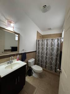 a bathroom with a sink and a toilet and a mirror at Habitación zen playa in Playa del Carmen