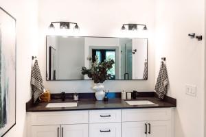 a bathroom with two sinks and a large mirror at ModTrio 3BR with ensuites & Garage Mins to Uptown in Charlotte +28 photos