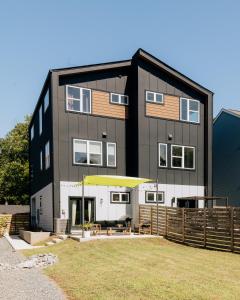 a large black building with a fence in front of it at ModTrio 3BR with ensuites & Garage Mins to Uptown in Charlotte