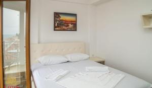 a bed with two white pillows in a room at Lotos - stan 423 in Dobra Voda