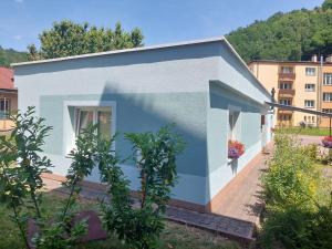 a small blue and white building with a window at BIKE apartments 1 in Hodruša