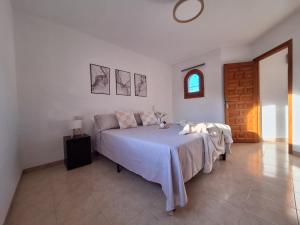 a bedroom with a bed and a table and a window at La Karina in Denia +28 photos
