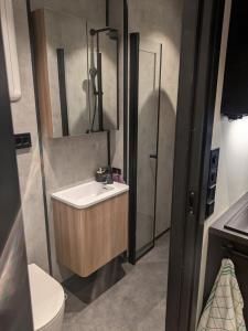 a bathroom with a sink and a toilet at Apartment in the middle of the city center in a quiet street in Stryn