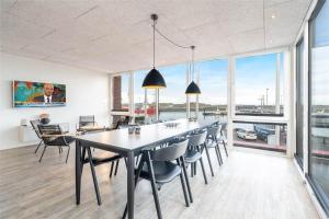a dining room with a large table and chairs at 804-Hvide-Sande-Havnegade-2-1-A in Hvide Sande