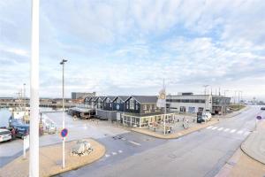 a city street with a building and a street with cars at 804-Hvide-Sande-Havnegade-2-1-A in Hvide Sande