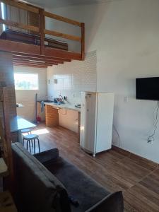 a kitchen and a living room with a white refrigerator at Apartamento completo in Prado +3 photos