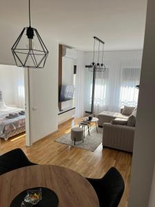 a living room with a table and a couch at Apartman Relax in Arandelovac