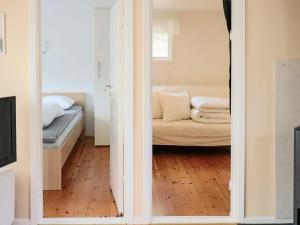 a view of a living room with a couch through a mirror at 4 star holiday home in MELLBYSTRAND in Mellbystrand