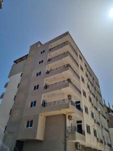 a tall building with balconies on the side of it at Appartement bord de mer in Mazer