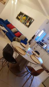 a living room with a table with chairs and a couch at Appartement bord de mer in Mazer