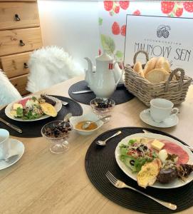 a wooden table with plates of food and a tea pot at Malinovy Sen in Habovka +66 photos