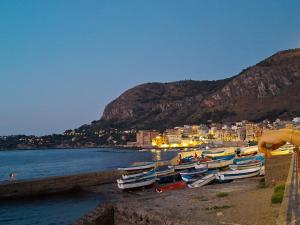 a group of boats on the shore of a beach at Casa Mirella in Aspra