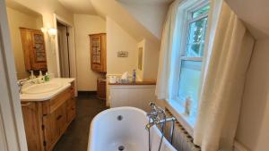 a bathroom with a tub and a sink and a window at Gîte La Belle Aventure B&B in Shawinigan +19 photos